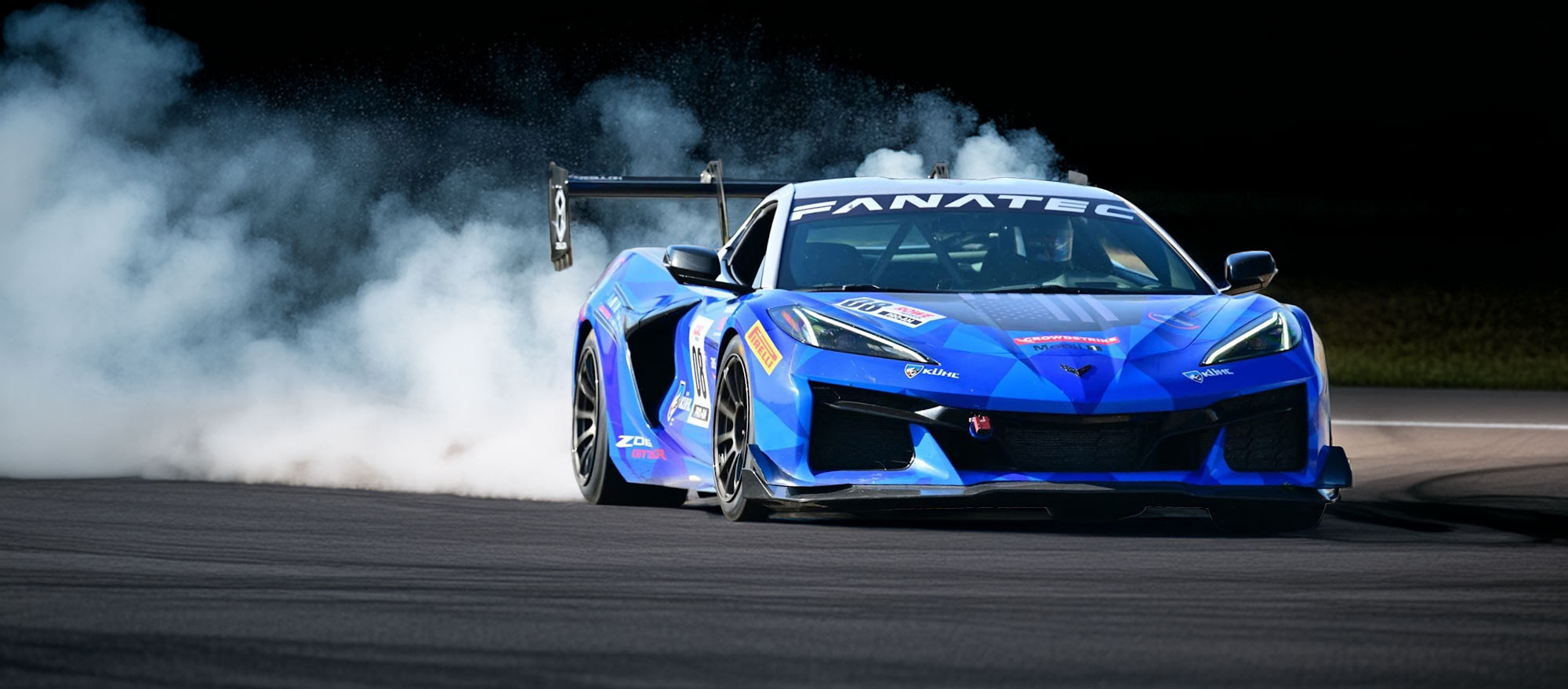 Corvette on-track kicking up tire smoke